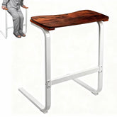 Sofa sit-to-stand assist device with a removable wooden tray table and white metal frame, shown with a person using the wooden handles to stand.