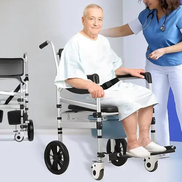 Man in a wheelchair with a nurse assisting him, on a plain background