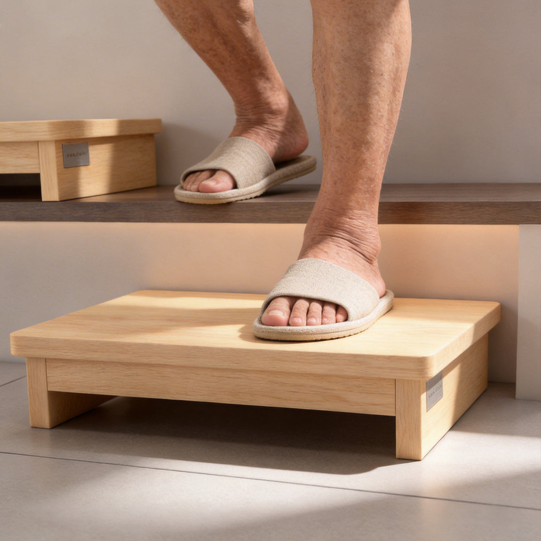 Close-up of a person stepping onto a wooden half-step stool placed in front of an indoor stair, showing the lower intermediate step.