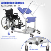 Manual sit-to-stand patient lift beside a wheelchair, showing the adjustable chassis opening from 20 to 34 inches and foot pedals for widening or narrowing the base.
