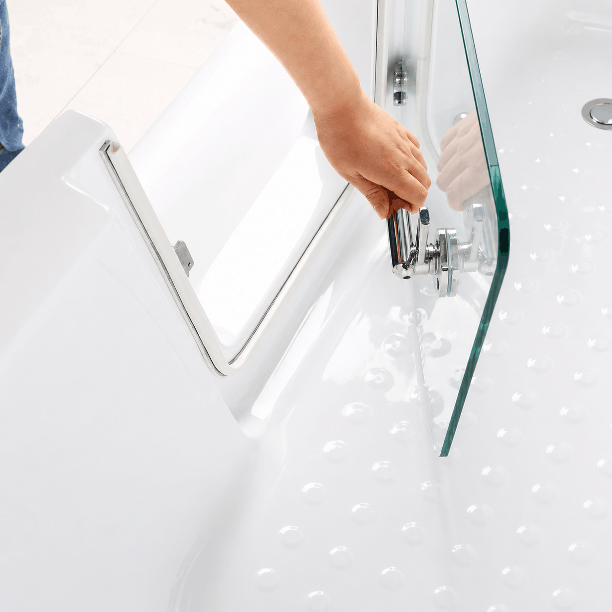 Close-up of walk-in bathtub glass door and secure metal locking handle