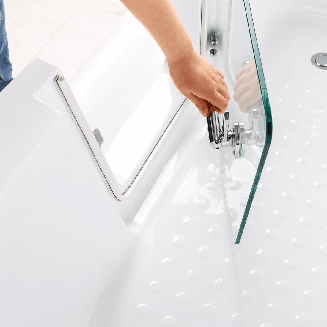 Close-up of walk-in bathtub glass door and secure metal locking handle