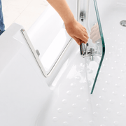 Close-up of walk-in bathtub glass door and secure metal locking handle