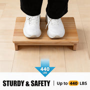 Person standing on a wooden half-step stool, with a graphic stating a maximum weight capacity of 440 lb.