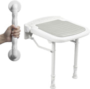 White wall-mounted folding shower seat with a gray cushion and adjustable legs, shown beside a separate bathroom grab bar held by a hand.