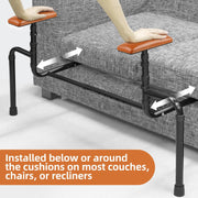 Adjustable sofa standing assist rails installed beneath the cushions of a gray couch, with hands on the padded armrests and arrows showing the frame extending under the seat.