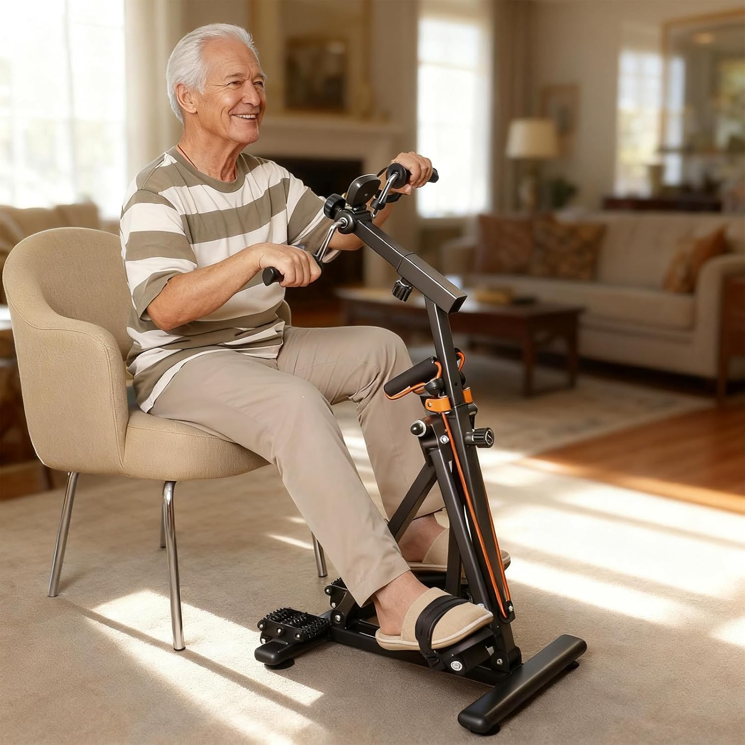 Older man seated in a living room using the adjustable arm and leg exerciser, with his hands on the rotating handles and feet on the pedals.