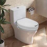 White raised toilet seat with lid installed on a toilet in a bathroom, shown with the lid closed and the side locking bracket visible.