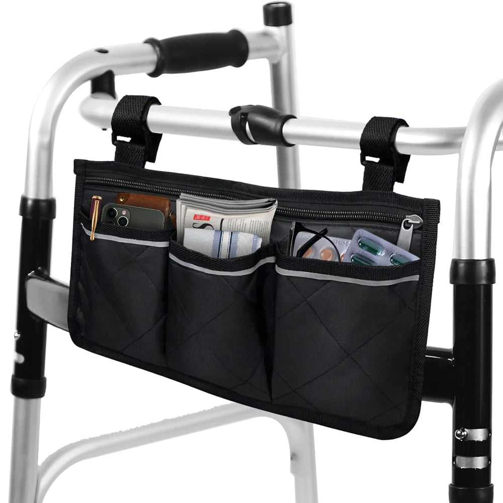 Black quilted walker bag attached to a folding walker, with three front pockets holding a phone, wallet, tissues, and other essentials.