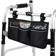 Black quilted walker bag attached to a folding walker, with three front pockets holding a phone, wallet, tissues, and other essentials.