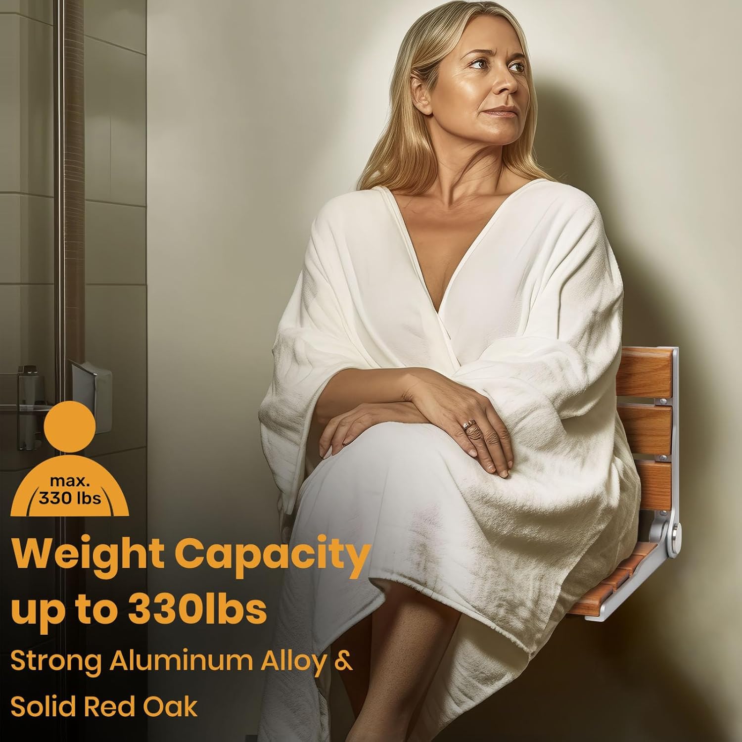 Woman in a white bathrobe seated on a wall-mounted wooden folding shower seat, with a graphic stating a 330 lb weight capacity.