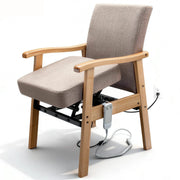 Wooden power lift assist chair with gray fabric upholstery, padded armrests, raised seat, under-seat lifting mechanism, and wired handheld controller on a white background.